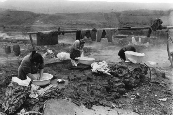 Women in the break-away republic of Chechnya wash clothes on the outskirts of Grozny from a hot water pipe. Most of the city's residents were without hot water and electricity during the Soviet Era.